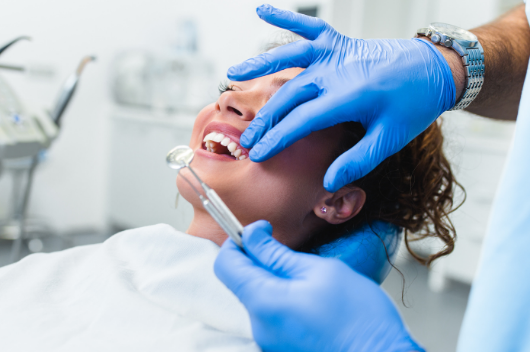 dentist looking into patients mouth